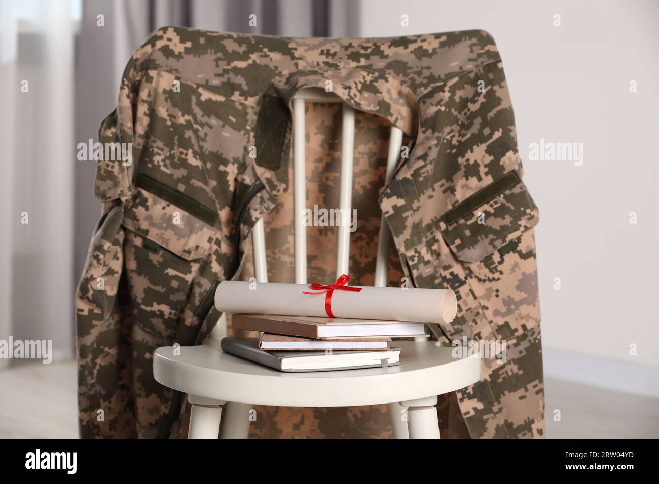 Army Print Chair Raspberry Chair with soldier uniform, notebooks and diploma indoors. Military ...