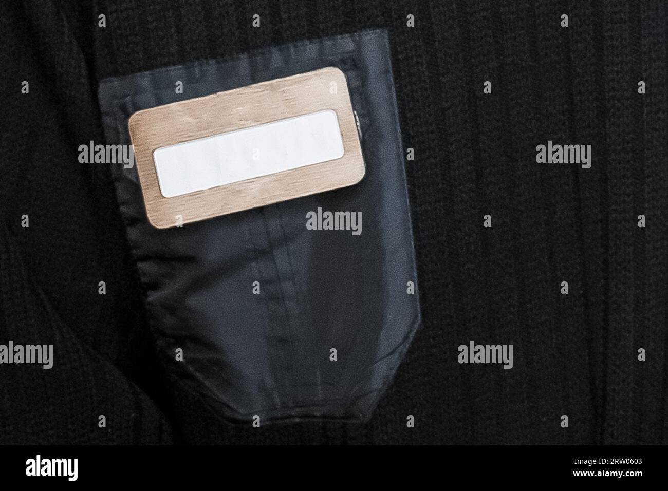Badge on dark clothes, security guard pocket empty space blank text for