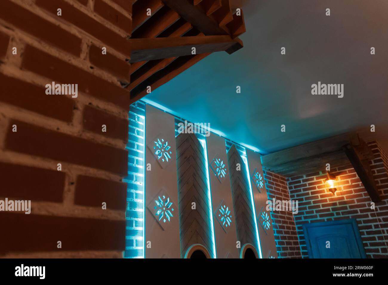 Decorative interior design element with brick walls and neon blue light. Stock Photo