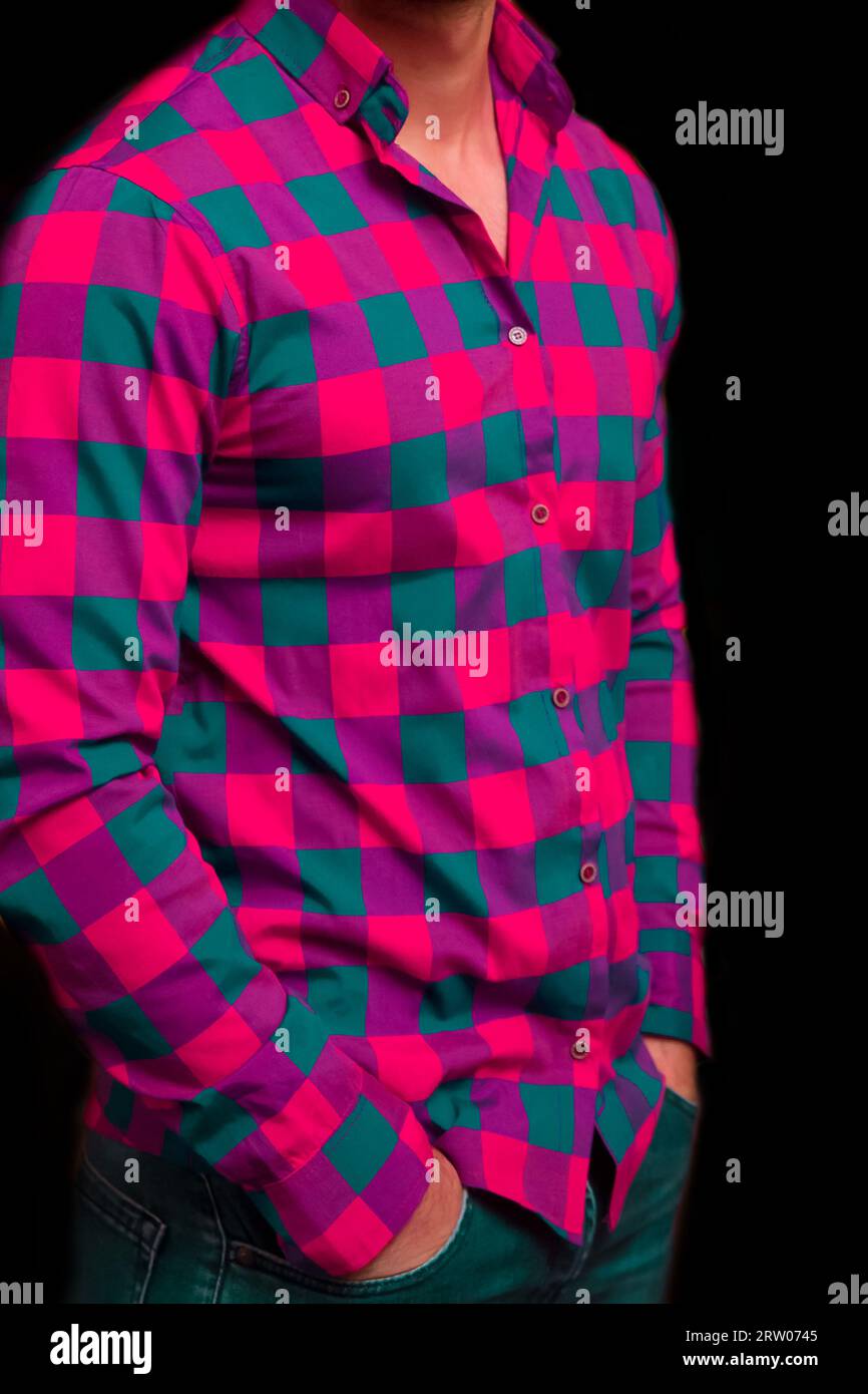 Men's business style clothing and fashion pink shirt with a large check blue pattern on a dark background. Stock Photo