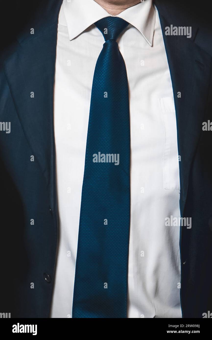 Men's business style clothing fashion white shirt and blue tie and suit jacket close-up soft focus. Stock Photo