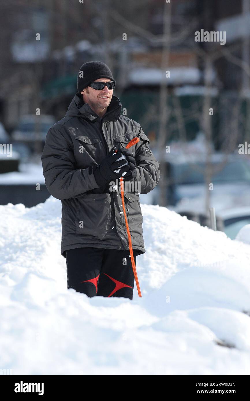 Manhattan, United States Of America. 29th Jan, 2011. NEW YORK, NY - JANUARY 29: Actor Hugh Jackman and his daughter Ava play in the snow as they take their new dog Mochi for a walk. All of them are in snow suits, even the dog is dressed for the occasion. on January 29, 2011 in New York City. People: Hugh Jackman Credit: Storms Media Group/Alamy Live News Stock Photo