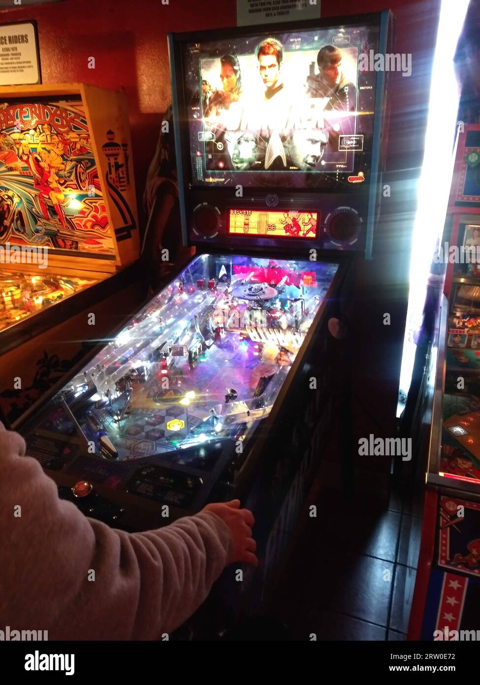 Someone playing on a pinball machine (NC State, 2023) Stock Photo