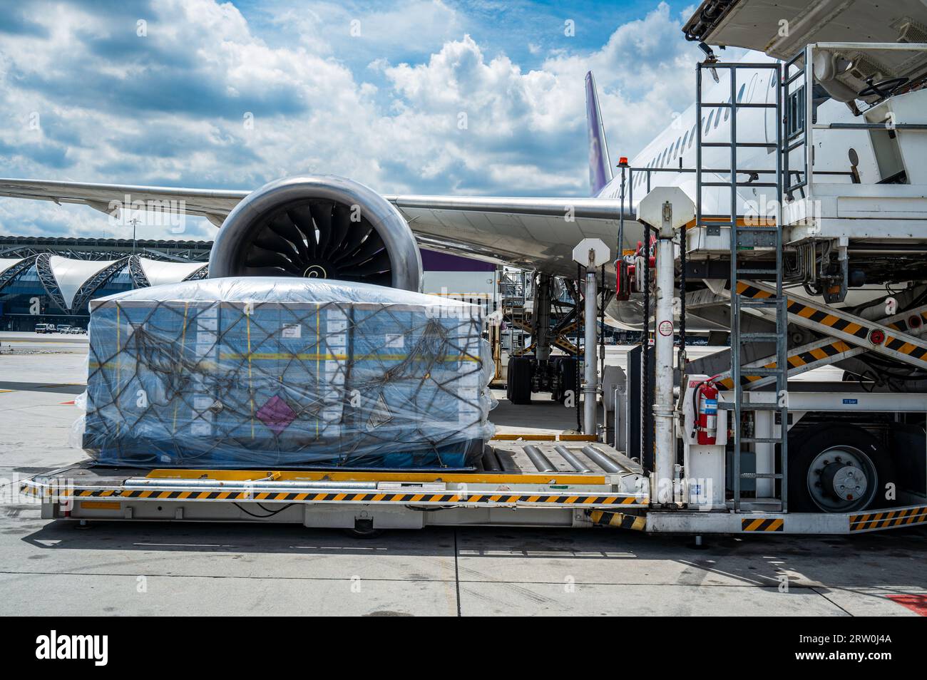 Air cargo logistic containers are loading to an airplane. Air transport