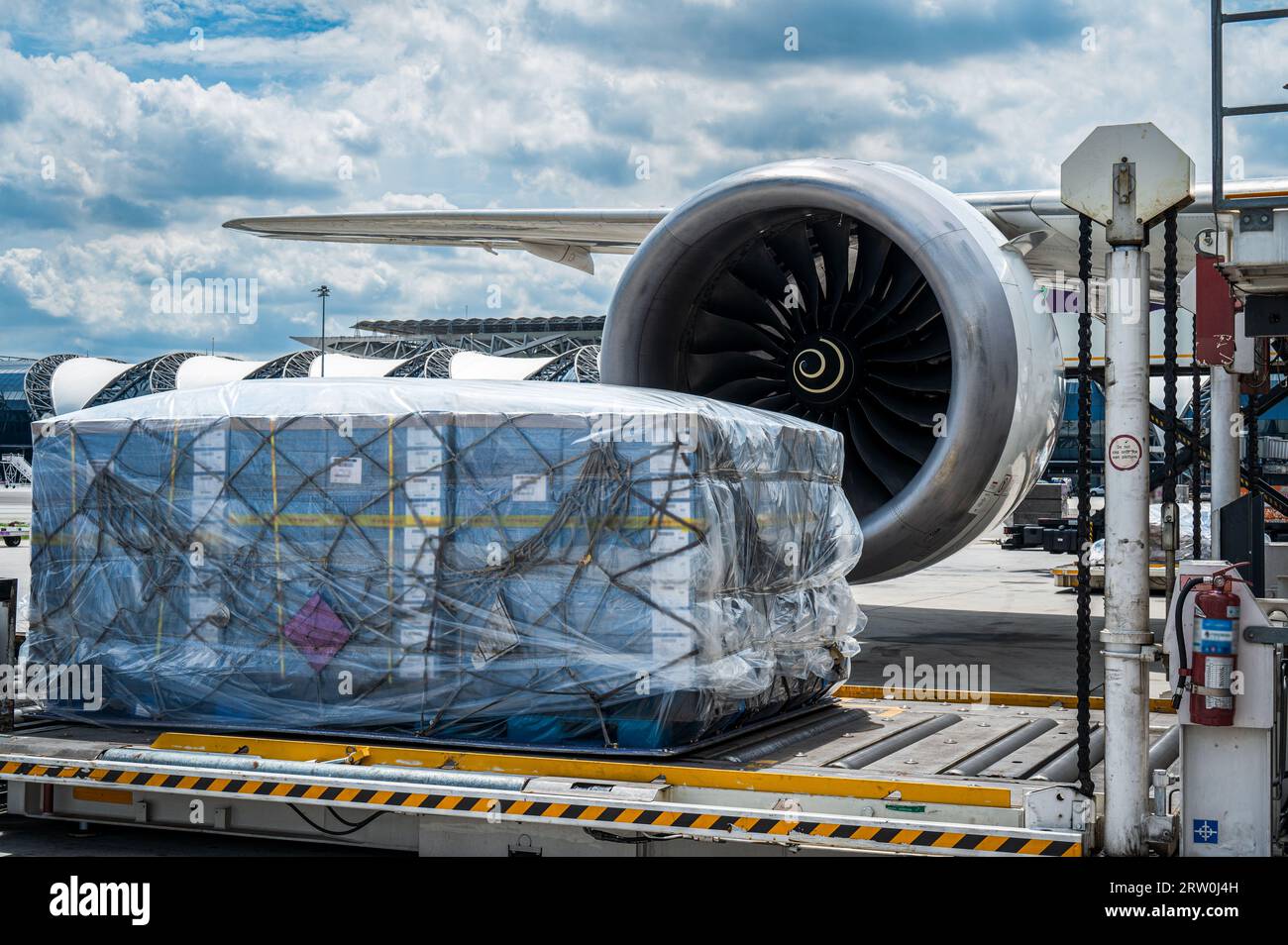 Air cargo logistic containers are loading to an airplane. Air transport