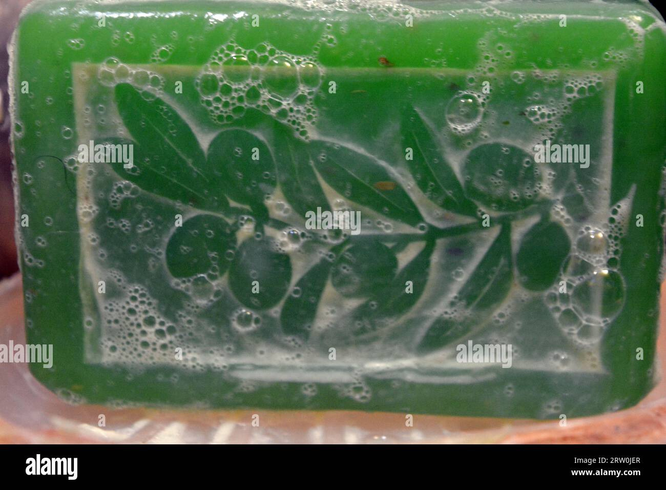 Large green soap with pattern and white foam Stock Photo - Alamy
