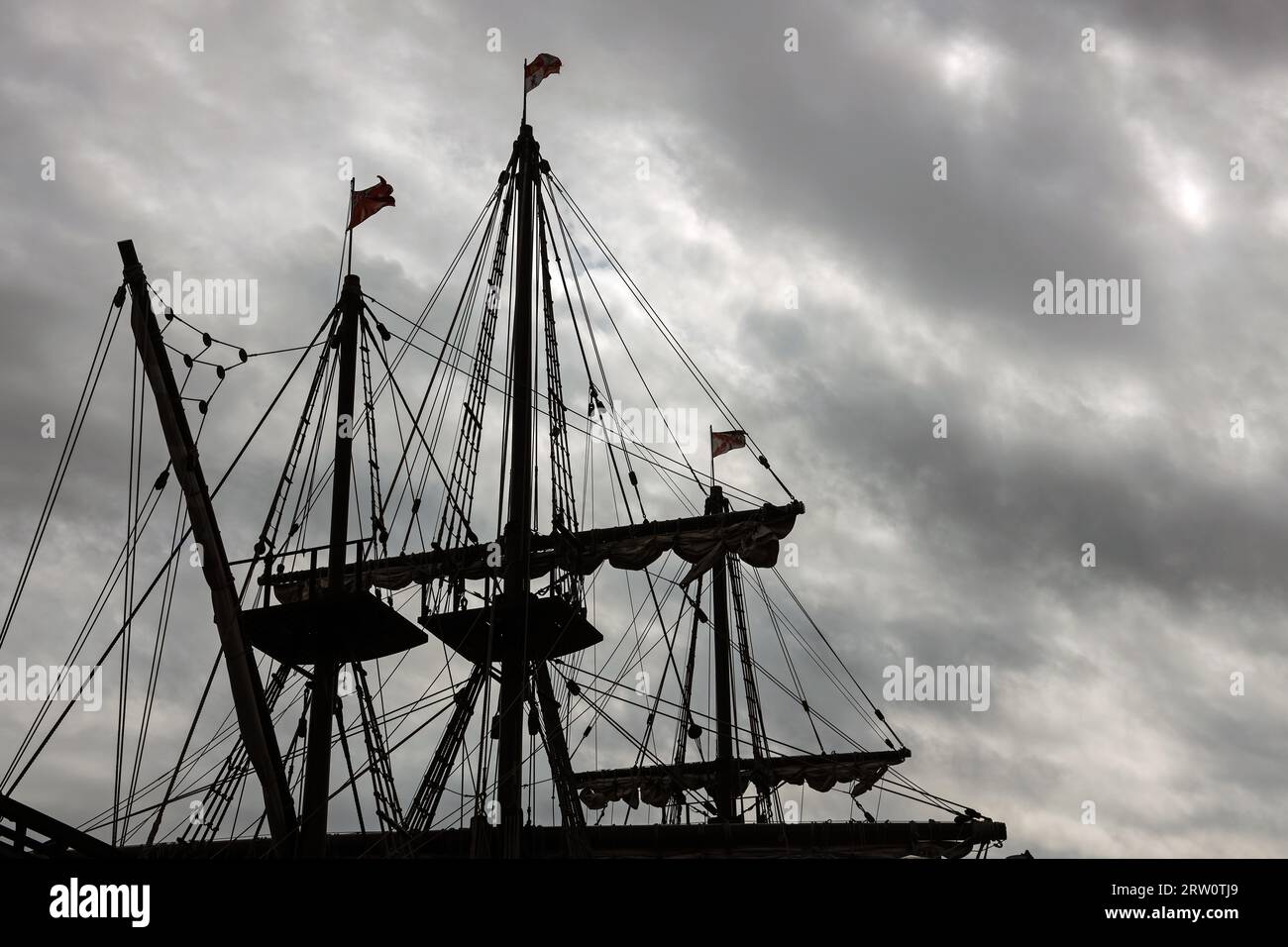 Silhouetted against dark clouds the rigging of the El Galeon berthed at