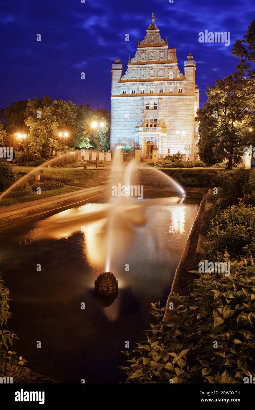 Park with fountain by night in Torun city, Poland, Collegium Maximum Museum of Nicolaus Copernicus University Stock Photo