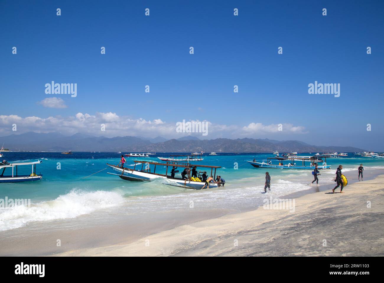 Gili Islands, Indonesia, July 09, 2015: Group of tourists arriving on Gili Trawangan after scuba diving trip Stock Photo