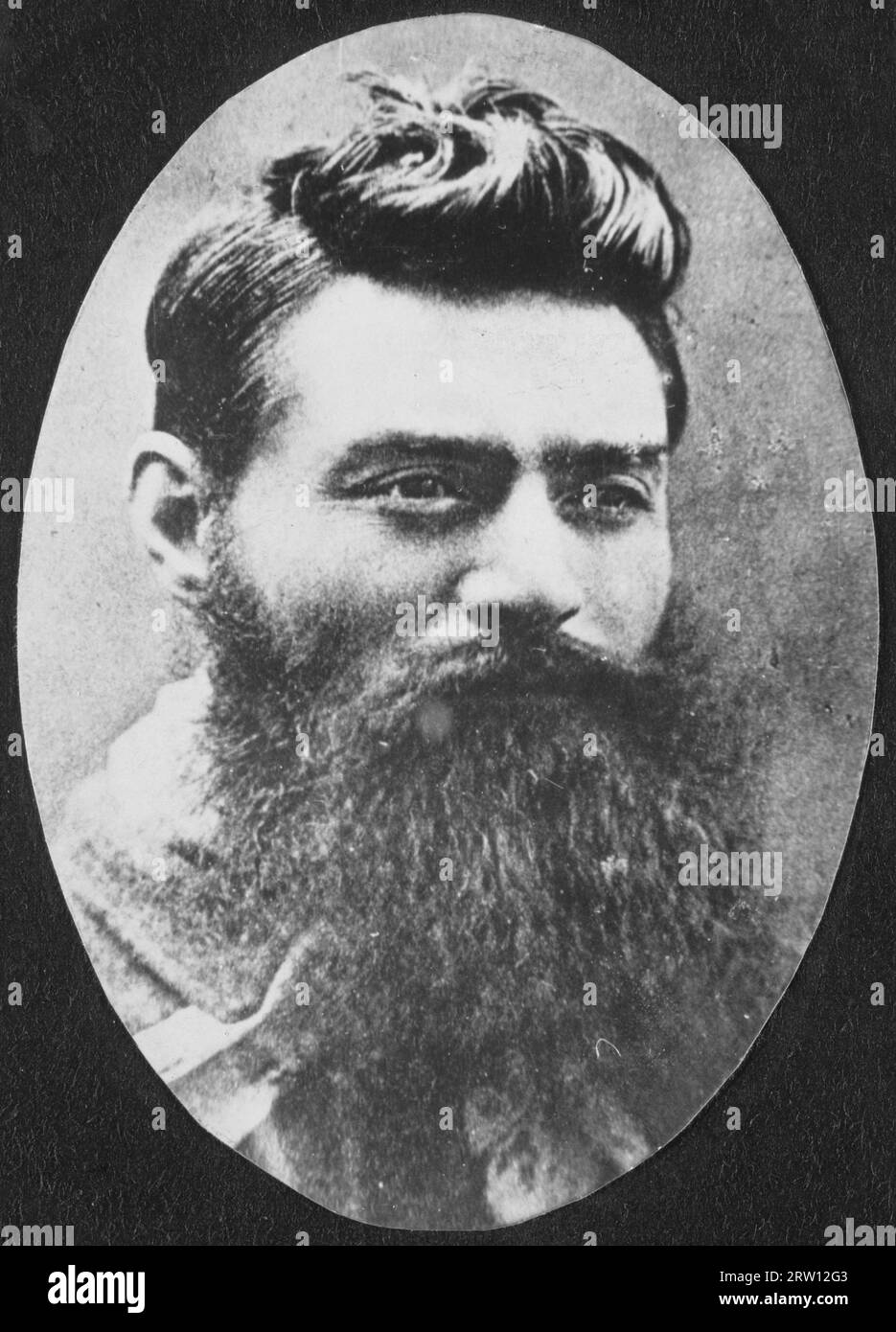 Portrait of bushranger Ned Kelly the day before he was hanged on November 11, 1880. by photographer Charles Nettleton.   Edward Kelly (December 1854 – 11 November 1880) was an Australian bushranger, outlaw, gang leader and convicted police-murderer. One of the last bushrangers, he is known for wearing a suit of bulletproof armour during his final shootout with the police. Stock Photo
