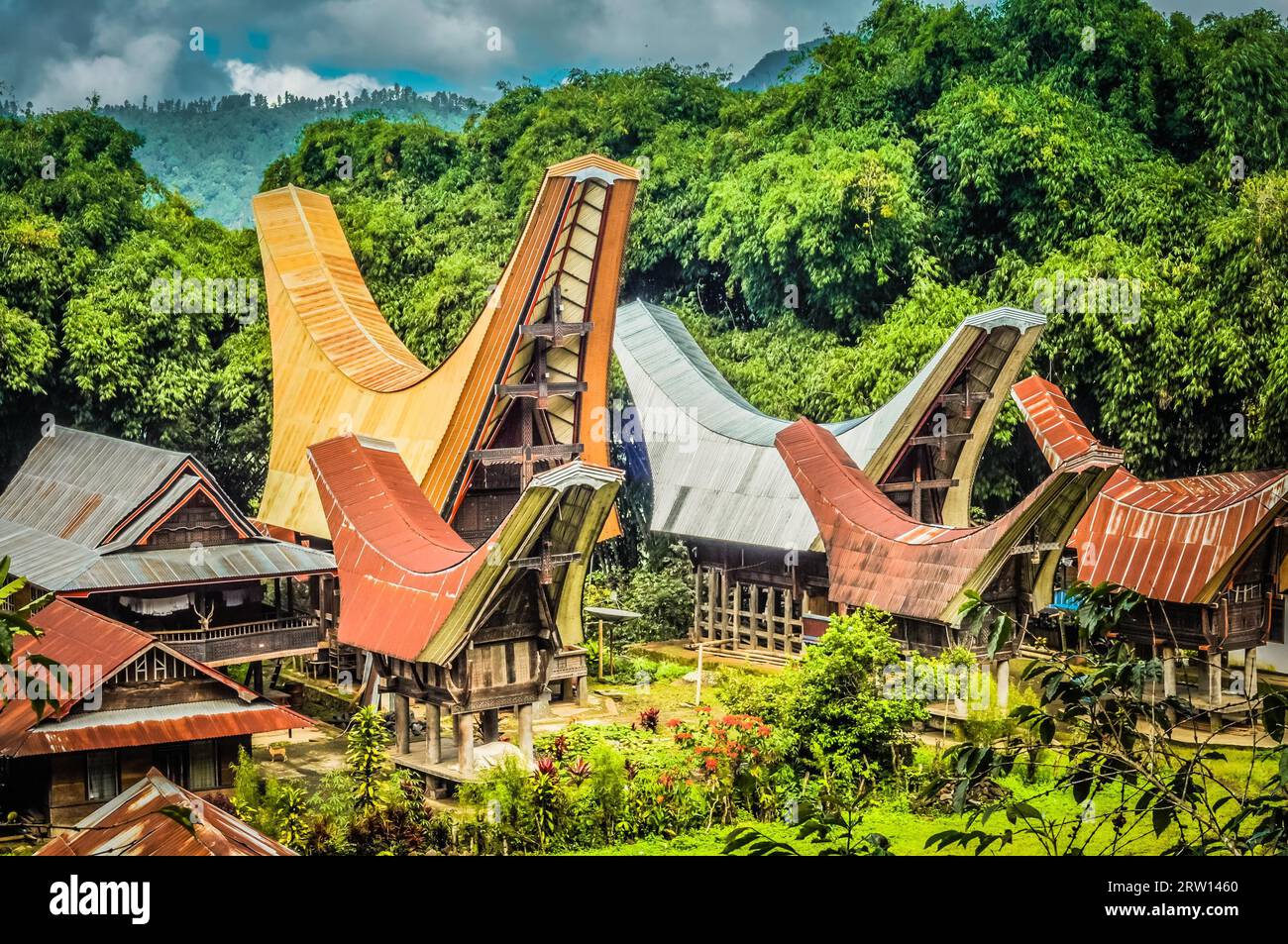 Photo of traditional ancestral houses, tongkonans, with large boat-shaped and saddleback roofs in Toraja region in Sulawesi, Indonesia Stock Photo
