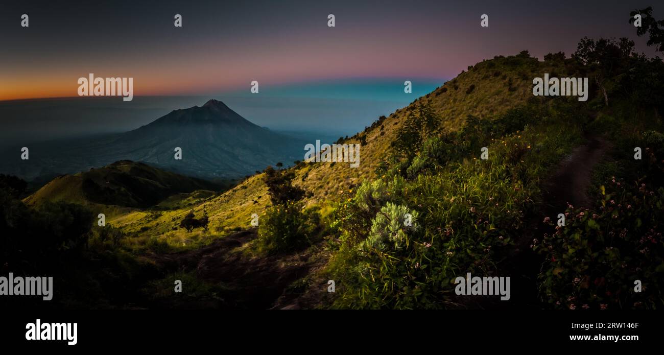 Panoramic photo of Mount Merbabu and surrounding mountains near Yogya in central Java province in Indonesia. In this region, one can only meet people Stock Photo
