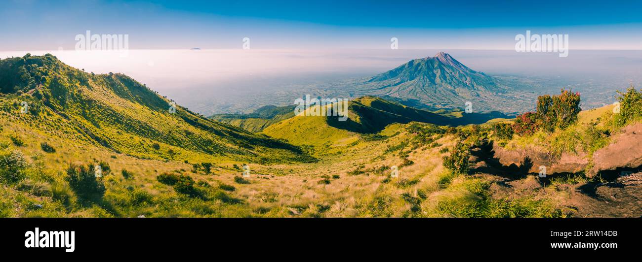 Panoramic photo of mountains and Mount Merbabu near Yogya in central Java province in Indonesia. In this region, one can only meet people from Stock Photo