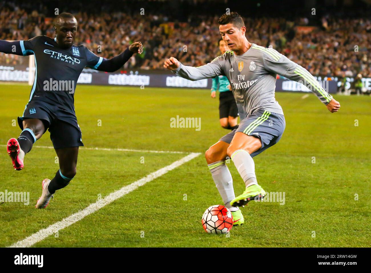 MELBOURNE, AUSTRALIA, JULY 24: Bacary Sagna and Cristiano Ronaldo tussle for the ball as Manchester City play Real Madrid in match 3 of the 2015 Stock Photo