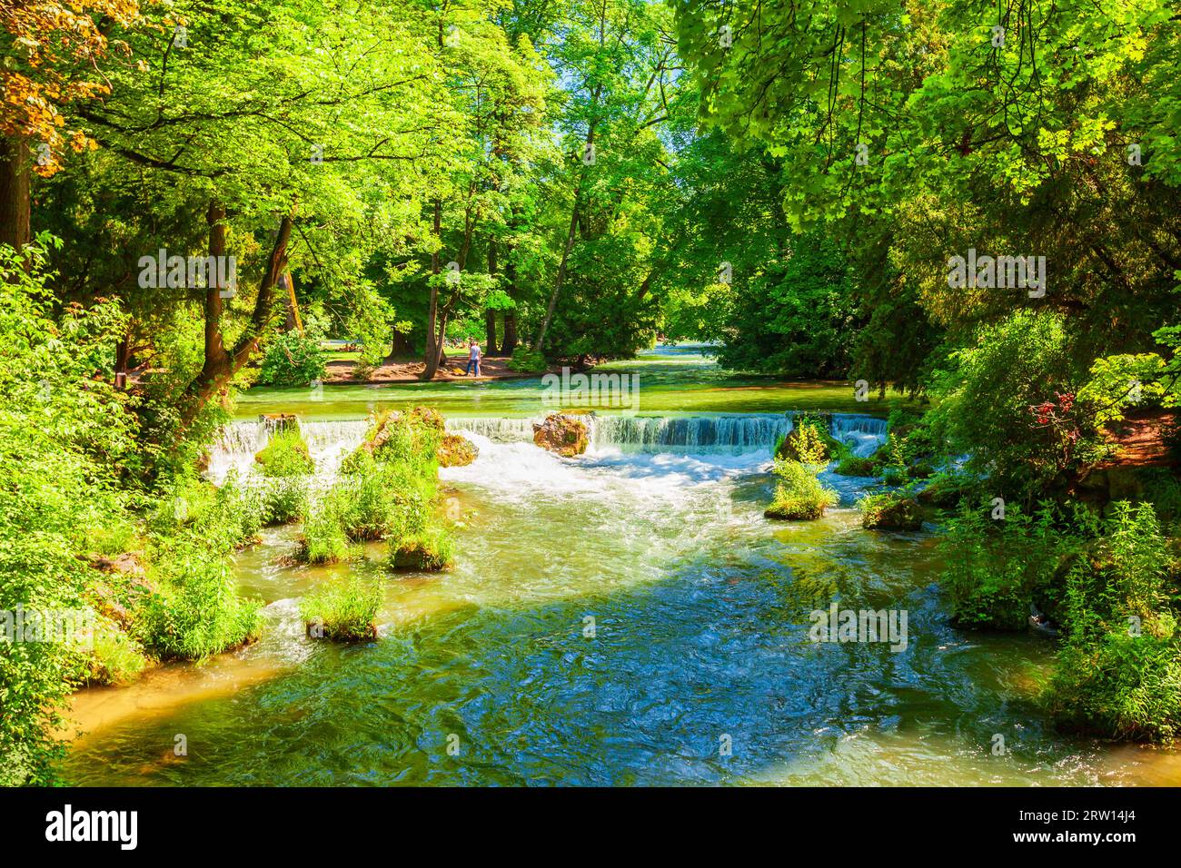 Waterfall at Schwabinger Bach stream in English Garden or Englischer