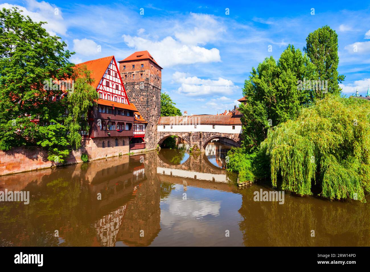 Wasserturm tower, Weinstadel medieval house and Henkerbrucke bridge at Pegnitz river in Nuremberg old town. Nuremberg is the second largest city of Ba Stock Photo