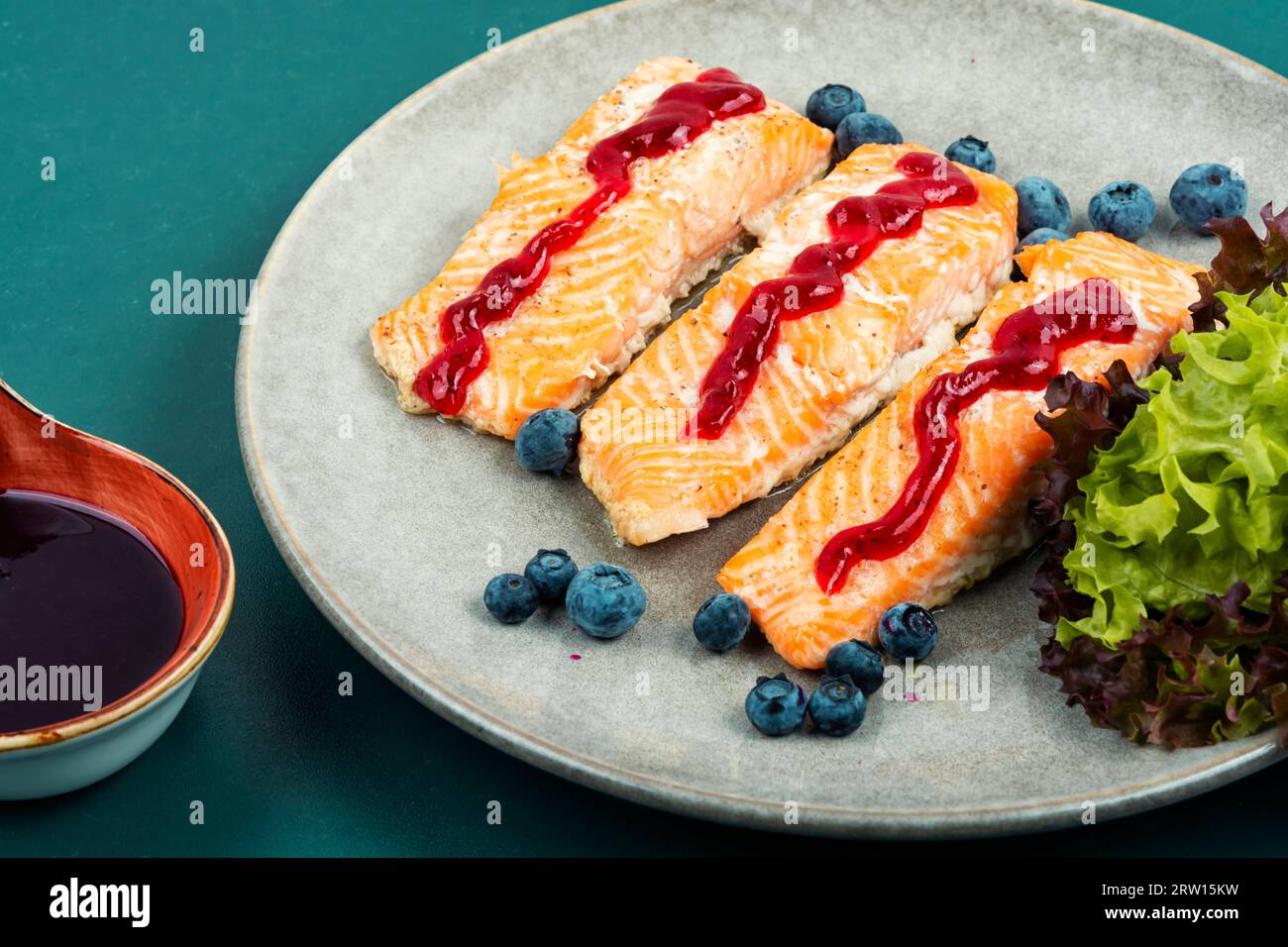Baked salmon fish with blueberry berry sauce. Salmon fillets, grilled