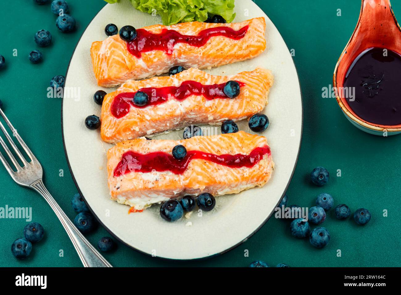 Baked salmon fish with blueberry berry sauce. Salmon fillets, grilled