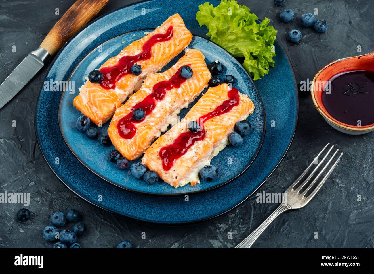 Baked salmon fish with blueberry berry sauce. Salmon fillets, grilled