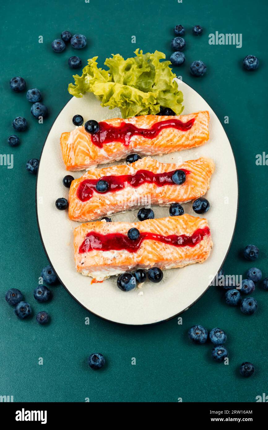 Baked salmon fish fillet with blueberry berry sauce. Seafood Stock