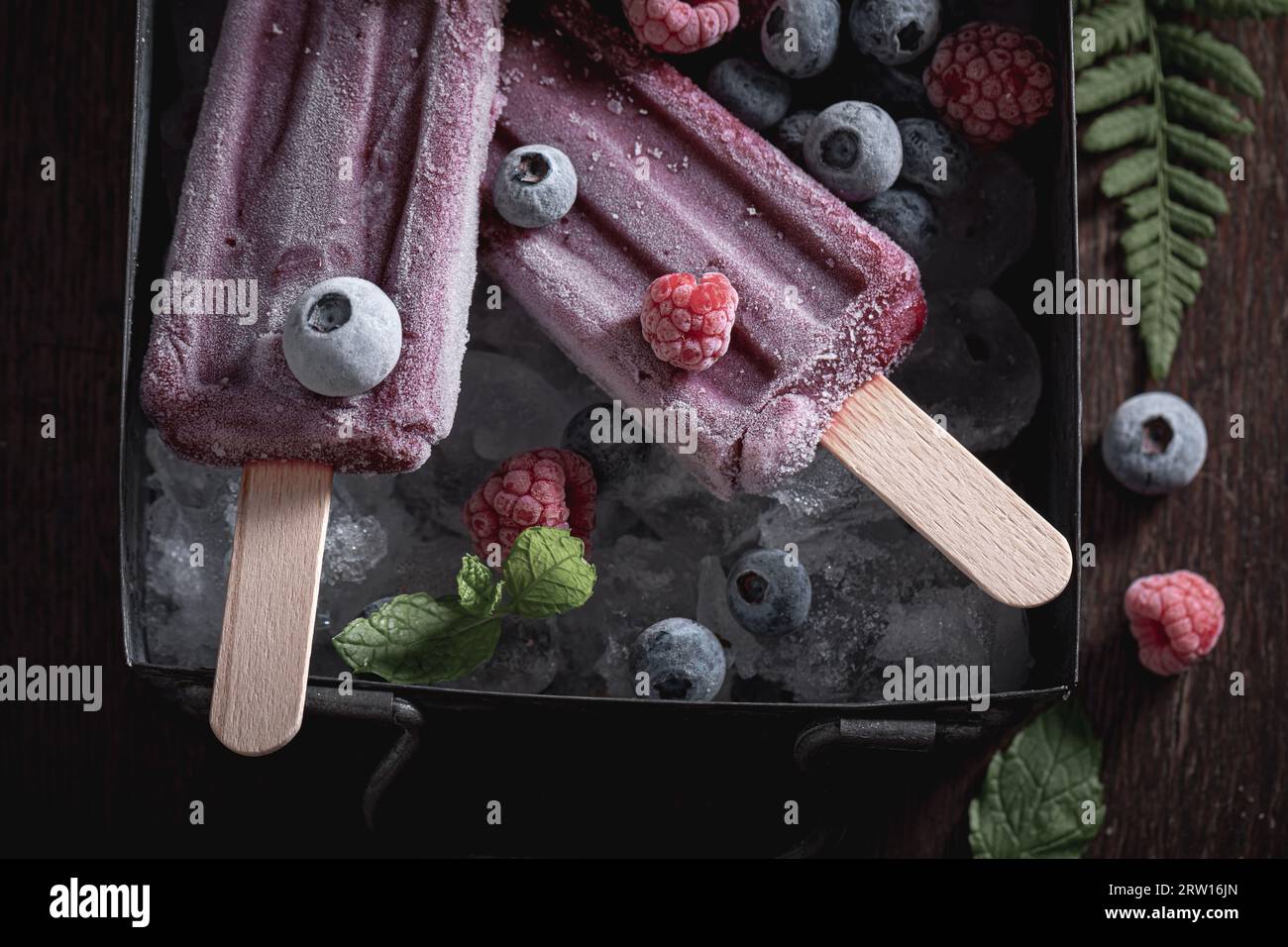 Cold ice cream sorbet flavored with raspberries and blueberries. Cold and sweet ice cream with berries. Stock Photo