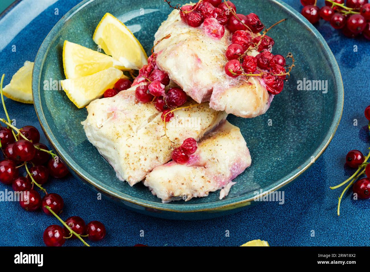 Cod fillet without skin baked with red currants. Atlantic cod fish ...