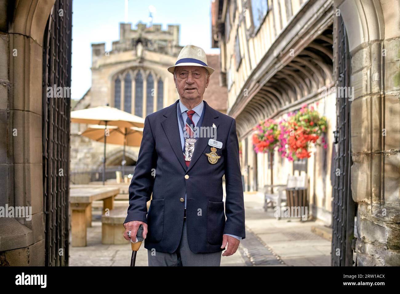 Lord Leycester Hospital resident ex military service man greeting visitors. Residential rest home for ex military servicemen. Warwick, England, UK Stock Photo