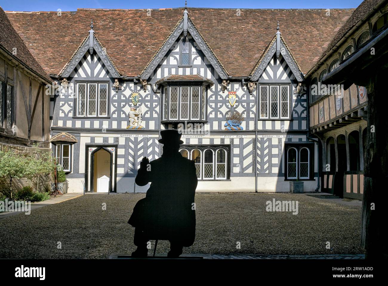 Lord Leycester Hospital and residential rest home for ex military servicemen with silhouette figure of elderly veteran resident. Warwick, England, UK Stock Photo
