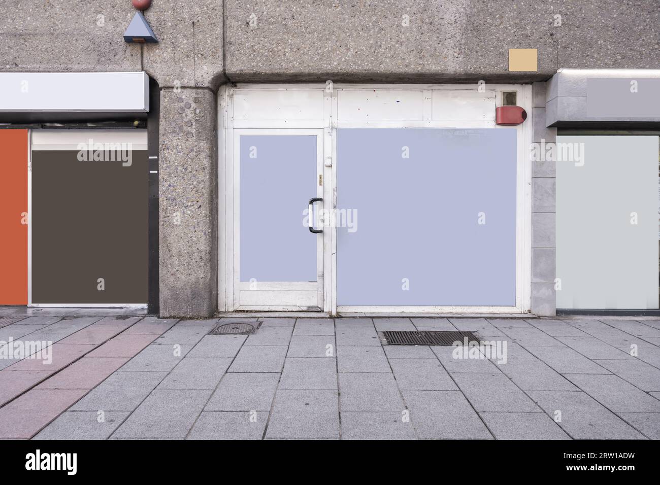 Facades of several commercial premises with white aluminum doors at