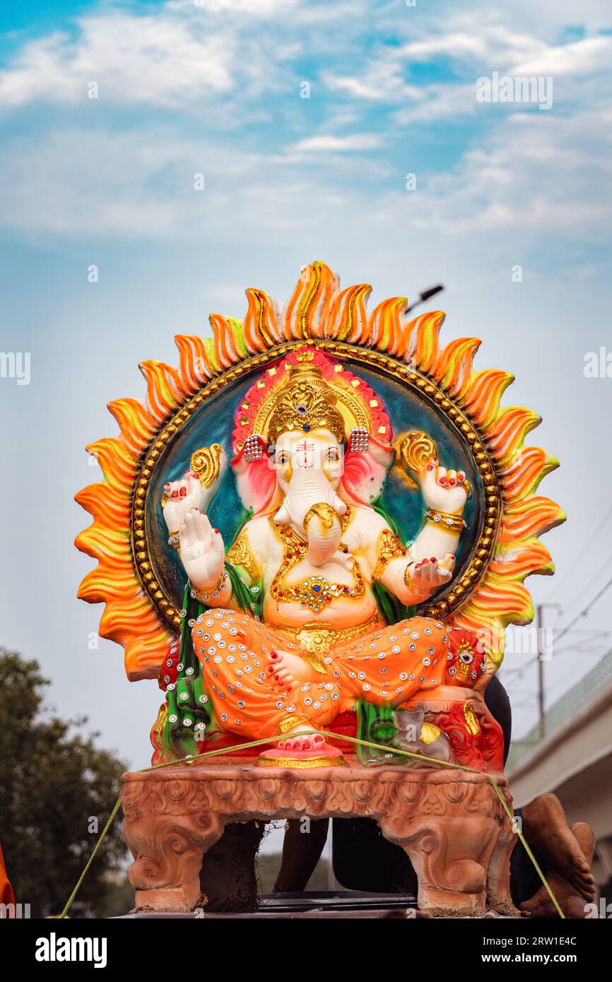 Ganesha Idol yellow orange and red color with beautiful skyline in