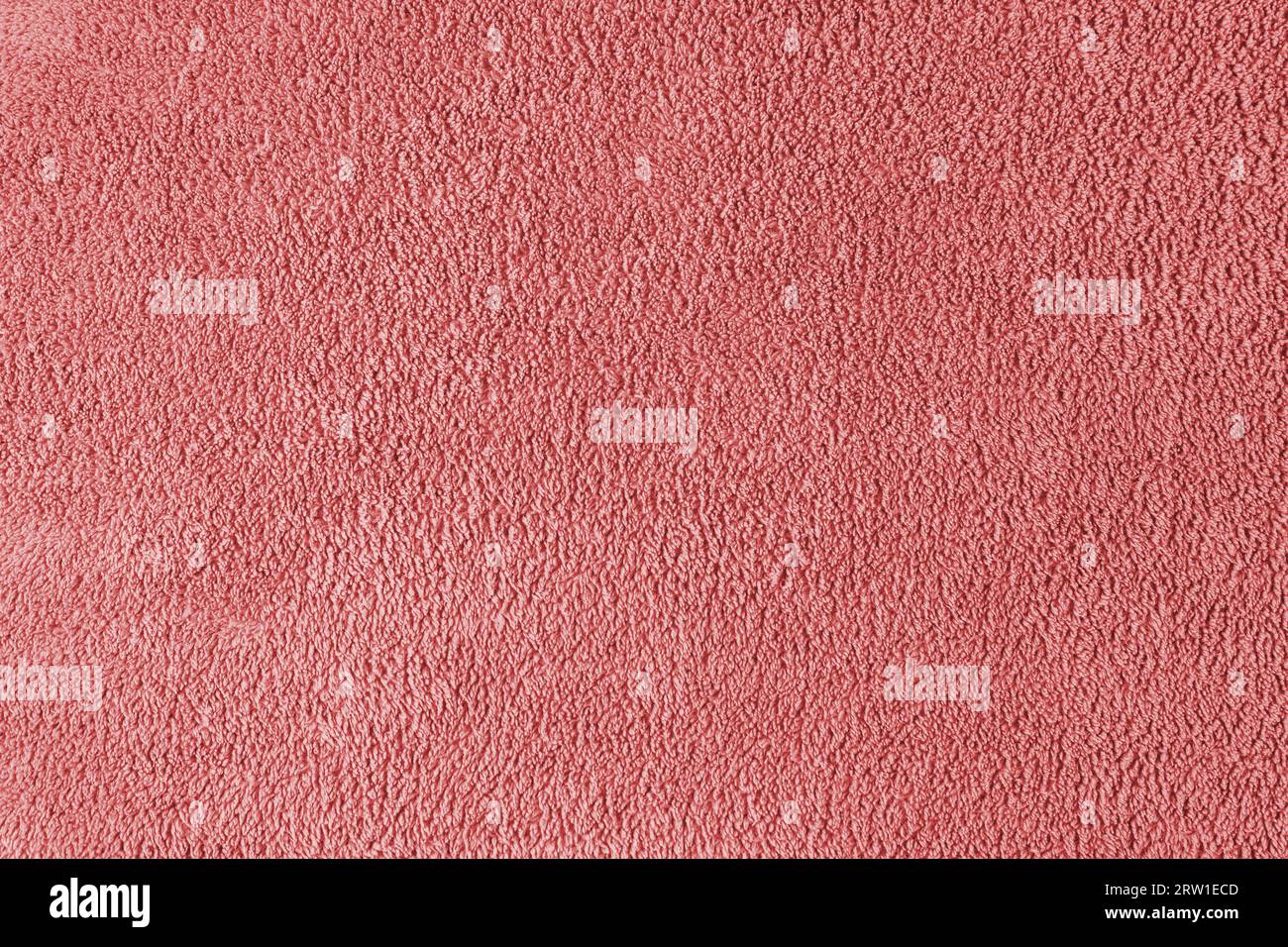 Terry cloth, red towel texture background. Soft fluffy textile bath or beach towel material. Top view, close up. Stock Photo
