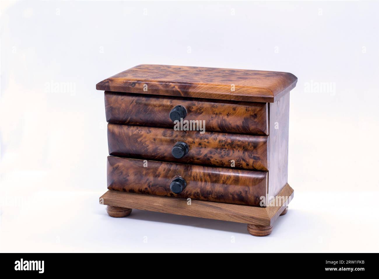 Tiny wooden chest of drawers handy for keeping small items of jewellery Stock Photo