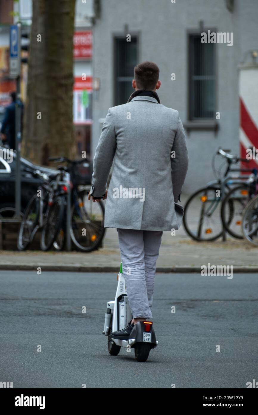 02.05.2023, Germany, Bremen, Bremen - Young man on an electric scooter in  the city centre. 00A230502D435CAROEX.JPG [MODEL RELEASE: NO, PROPERTY  RELEAS Stock Photo - Alamy