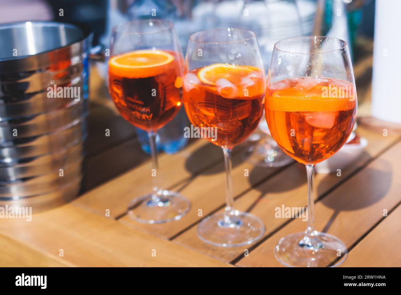 View of alcohol setting on catering banquet table, row line of orange red colored aperitif