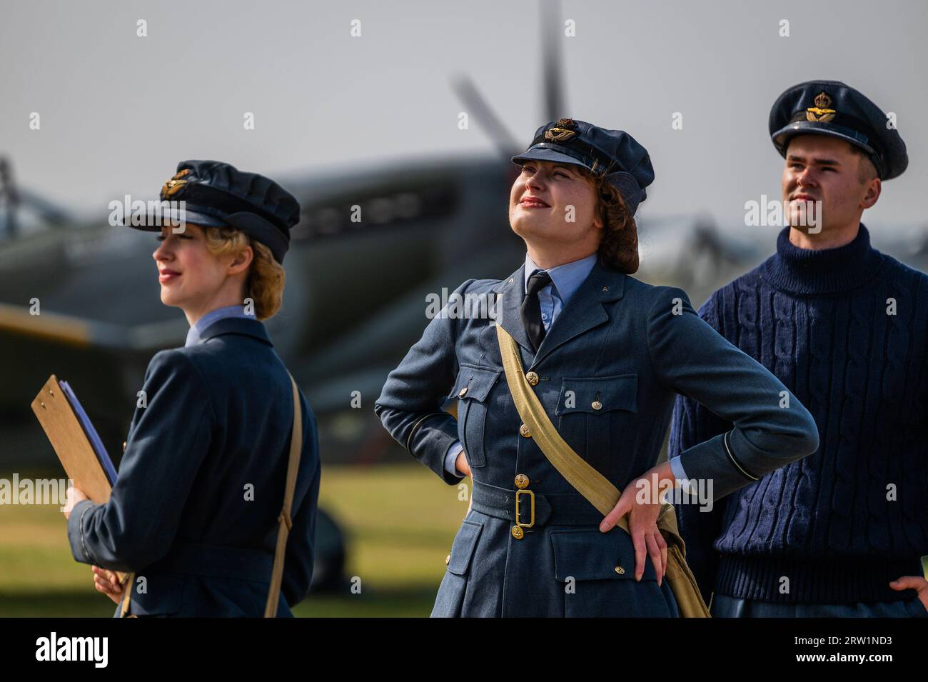 Duxford, UK. 16th Sep, 2023. Living history re-enactors in period RAF uniforms walk the flight line - The Duxford Battle of Britain Air Show at the Imperial War Museum (IWM) Duxford. Credit: Guy Bell/Alamy Live News Stock Photo