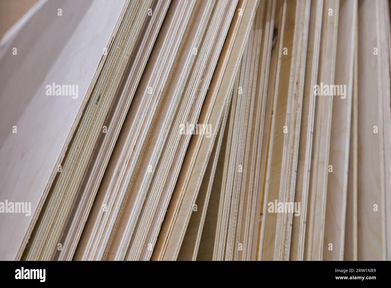 stack of vertical standing leaning plywood sheets in warehouse Stock