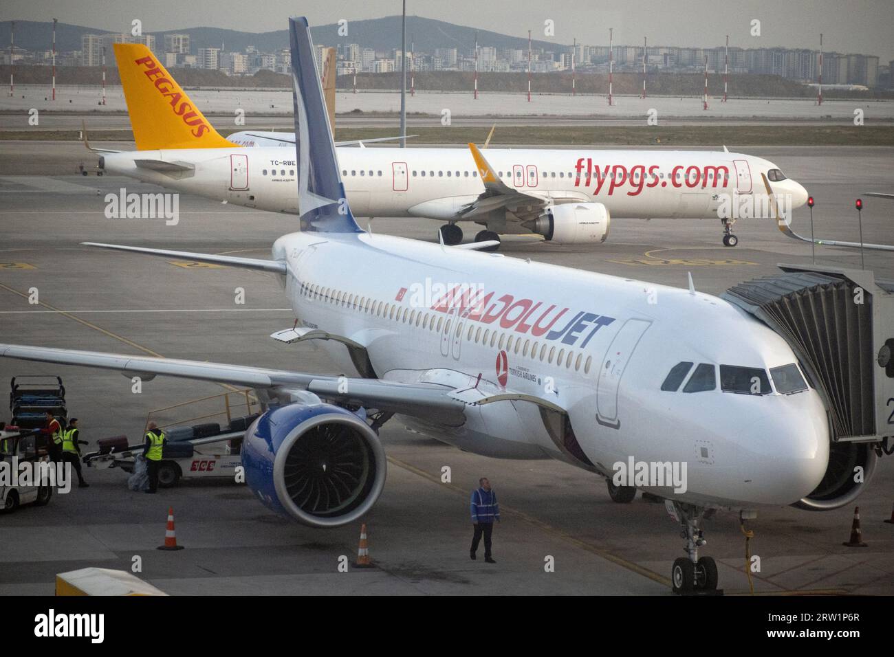 21.03.2023, Turkey, Istanbul, Istanbul - Aircraft of Anadolujet and Pegasus Airlines on the apron of Istanbul-Sabiha Goekcen Airport. 00S230321D281CAR Stock Photo