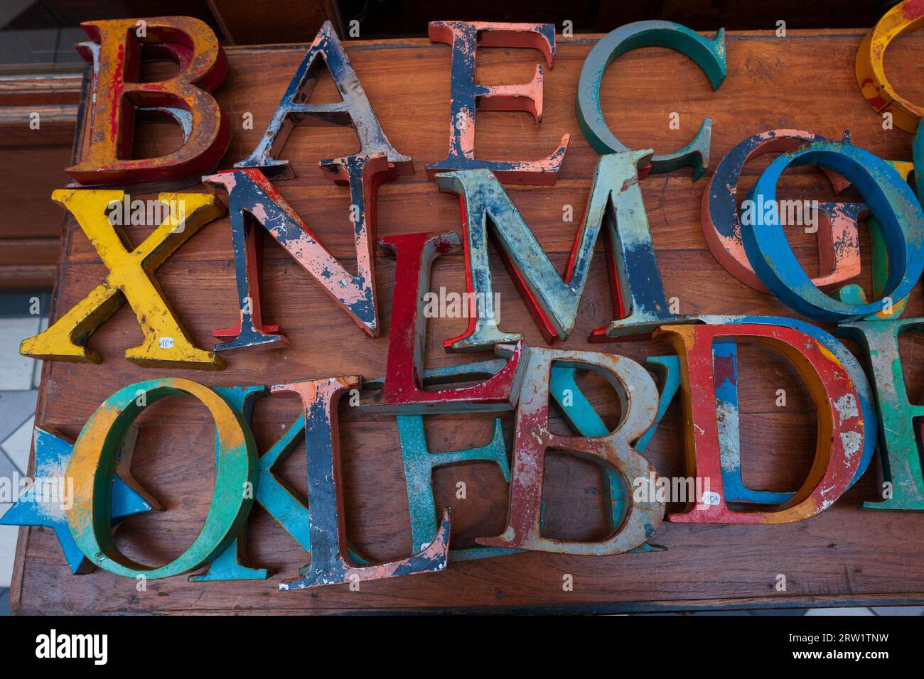 Metal letters on a wooden table outside a shop in the Passage du Grand Cerf, Paris, France Stock Photo