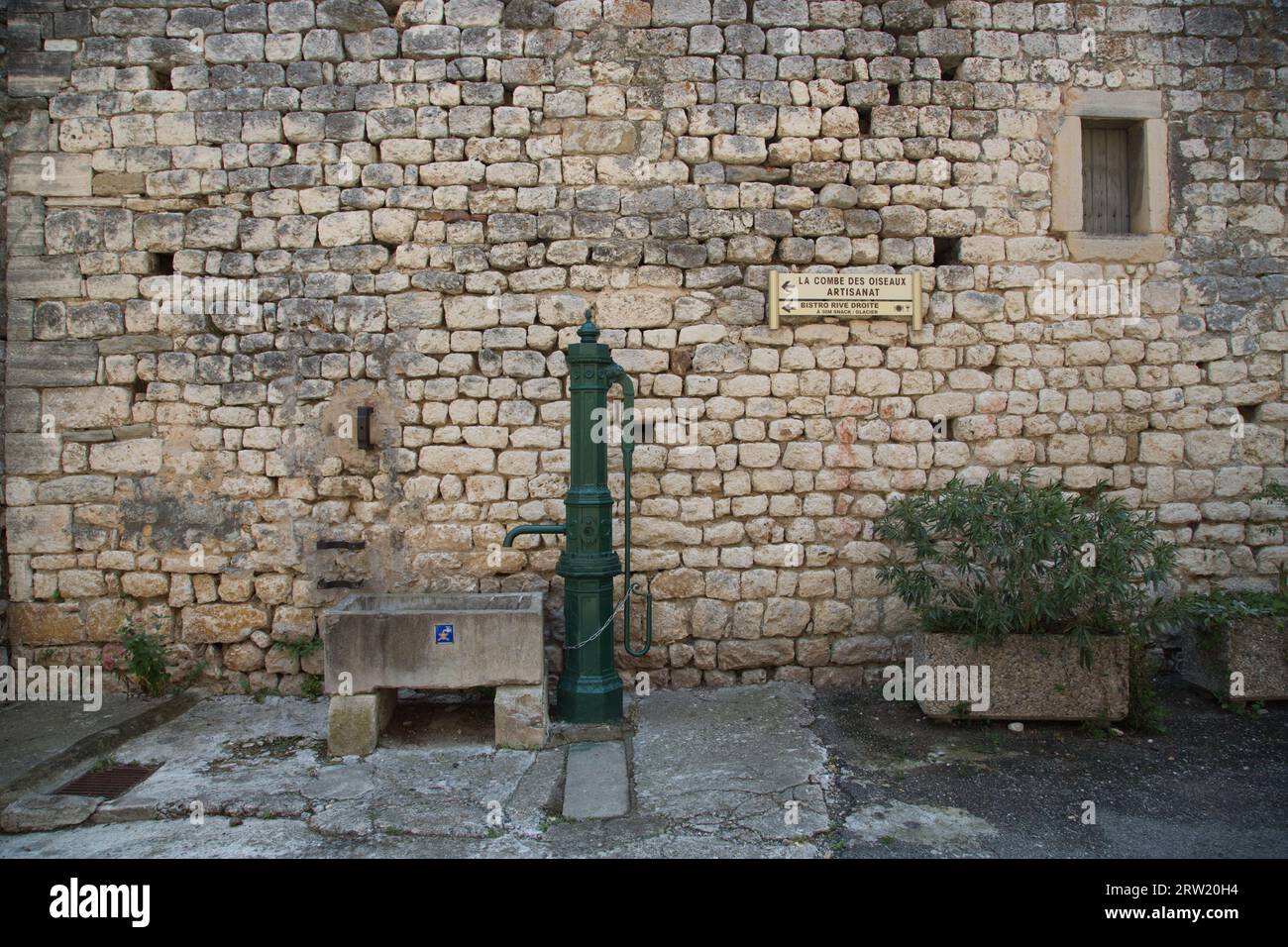 an old fountain in front of a stone wall. Stock Photo