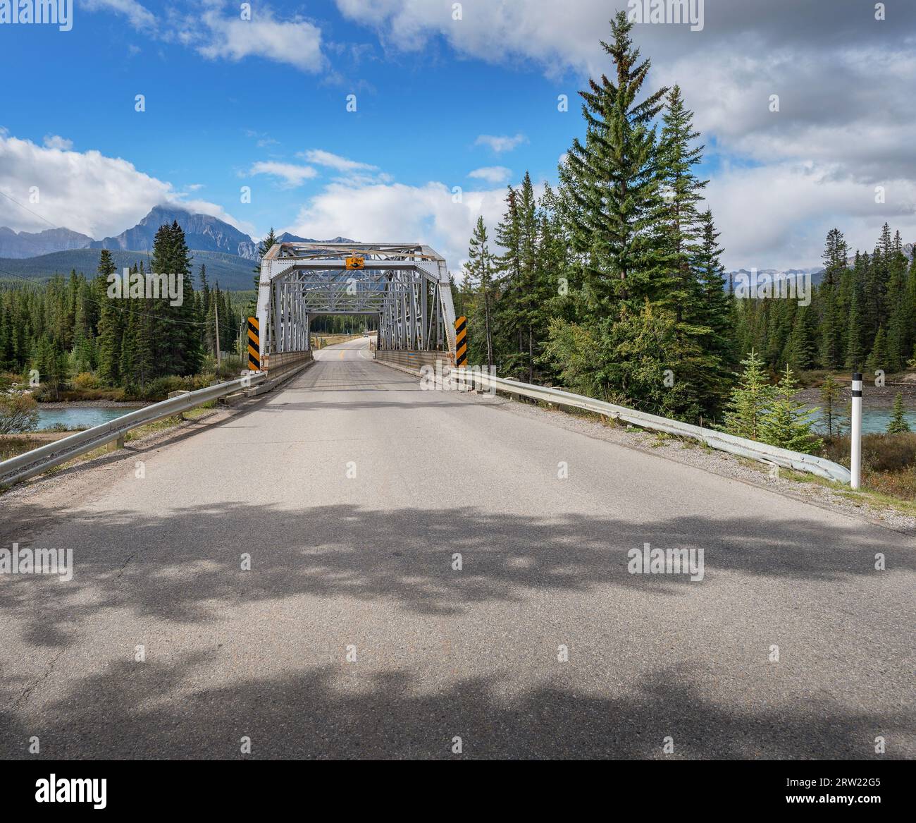 Highway and old steel truss bridge over the Bow River in the Rocky Mountains of Banff National Park, Alberta, Canada Stock Photo