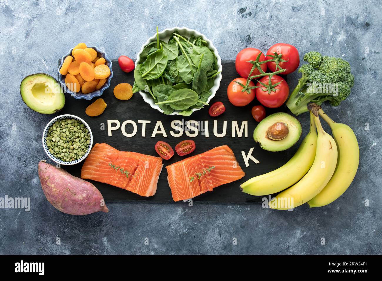 An assortment of foods high in potassium with the chemical element symbol K. Stock Photo