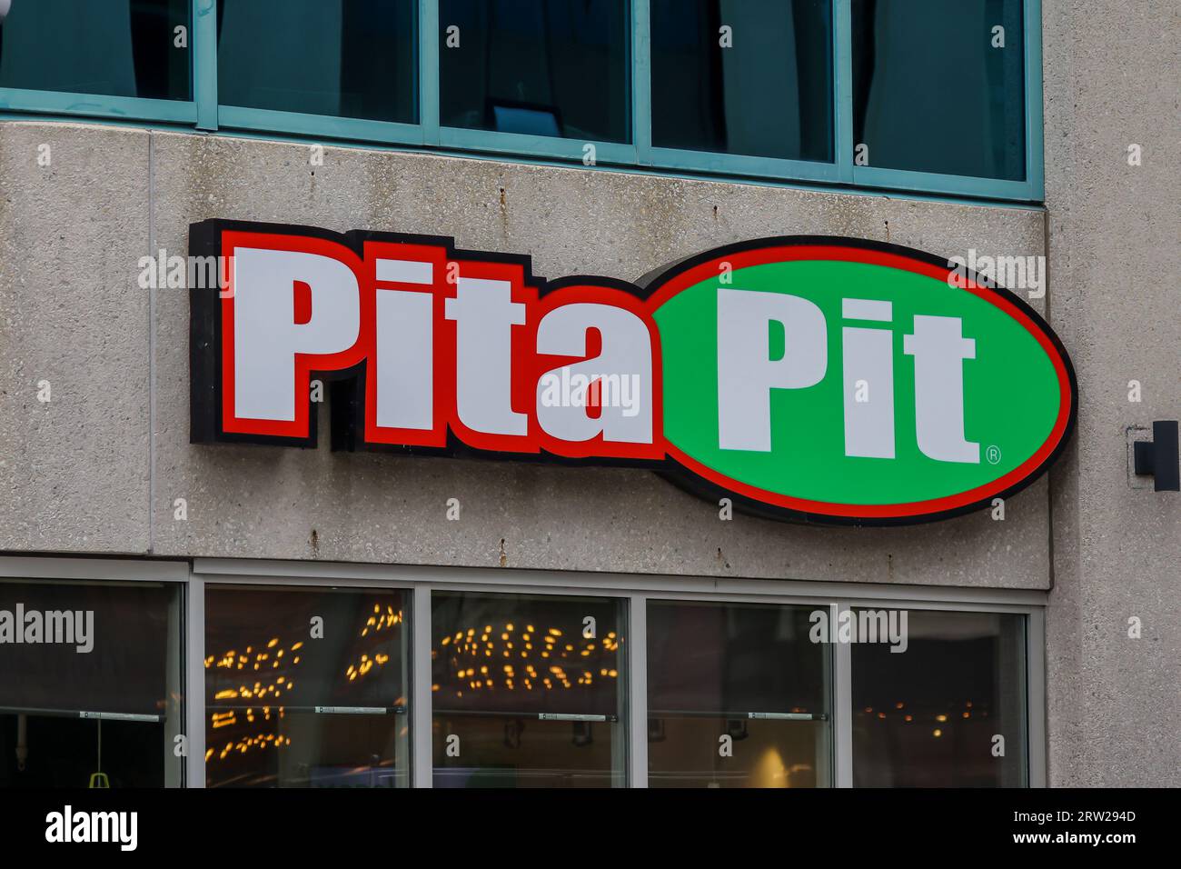 Pita Pit banner at restaurant. Canadian quick-service restaurant franchise serving pita sandwiches with fresh vegetables, grilled meat and sauces. Stock Photo