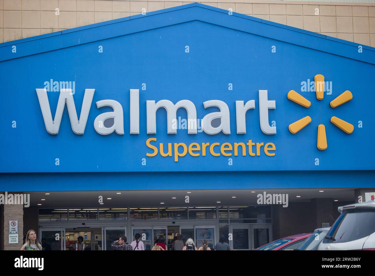 Walmart banner at store. Wal-mart Store Inc is an American multinational retail corporation that operates chain of hypermarkets aka supercenters. Stock Photo