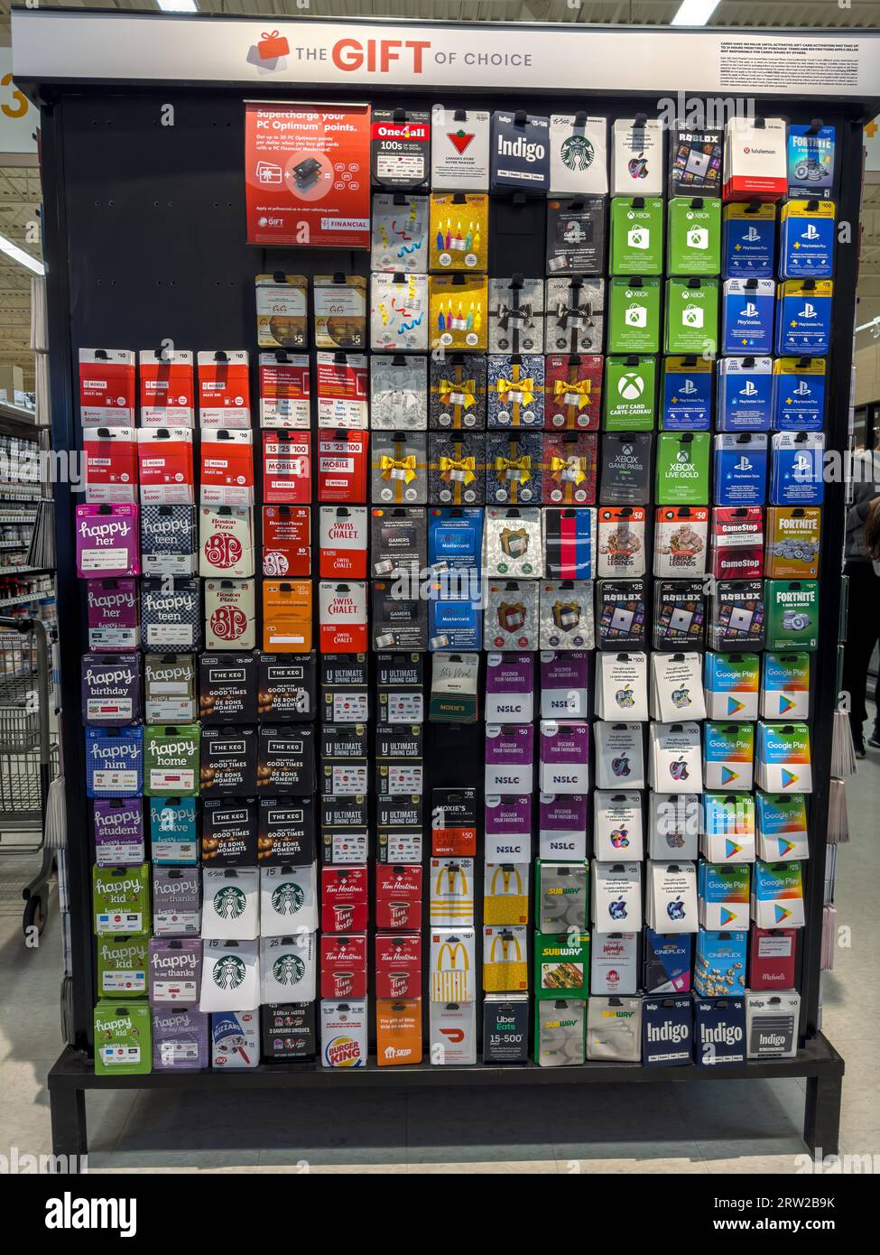 Gift Cards of multiple popular brands at a Supermarket Store. Assorted holiday gift cards of various denominations displayed on a flat panel. Stock Photo