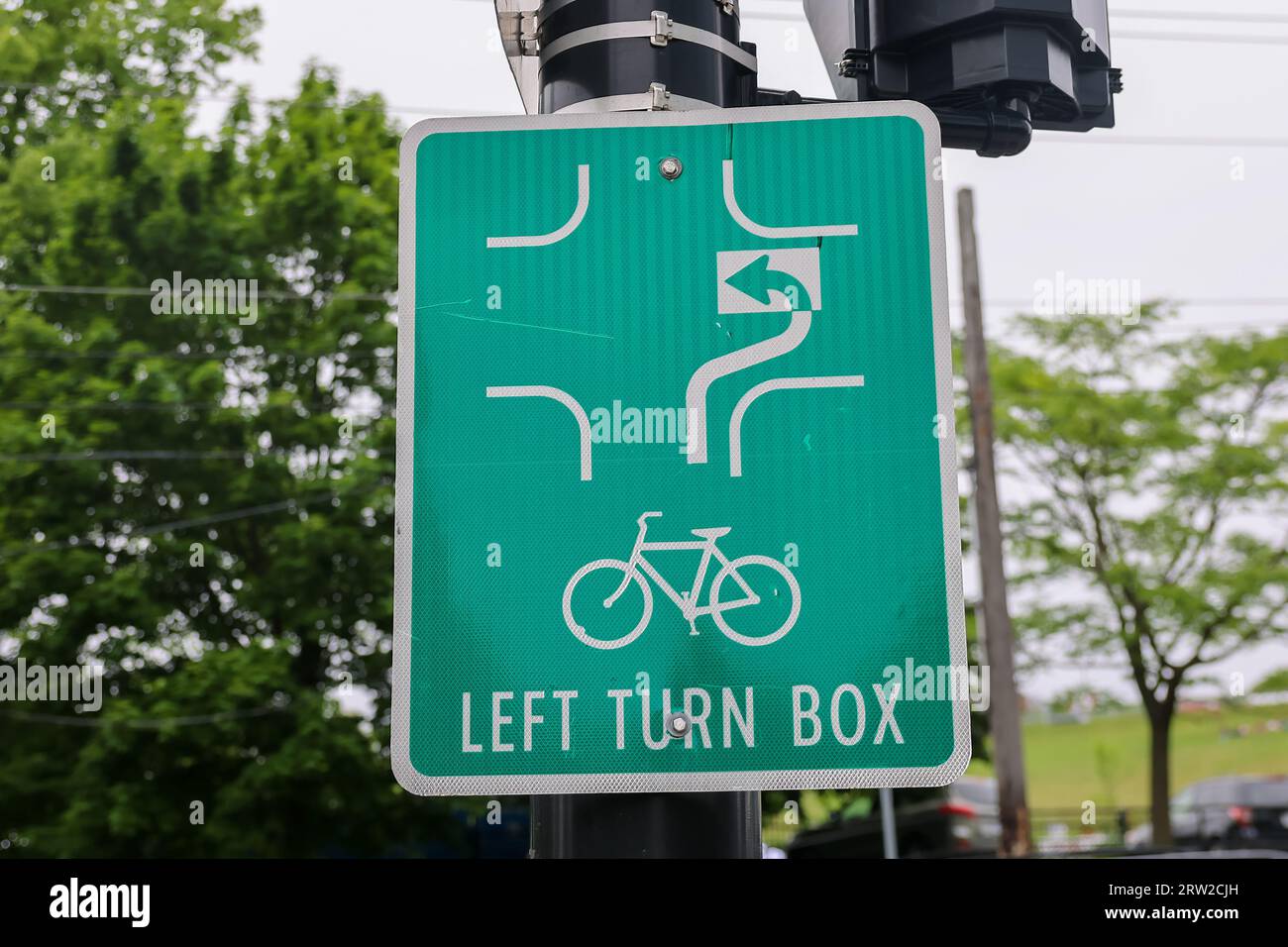 Bicycle lane LEFT TURN BOX with arrows indicating how to make the left turn for the bicyclists. Bike lane intersection Stock Photo