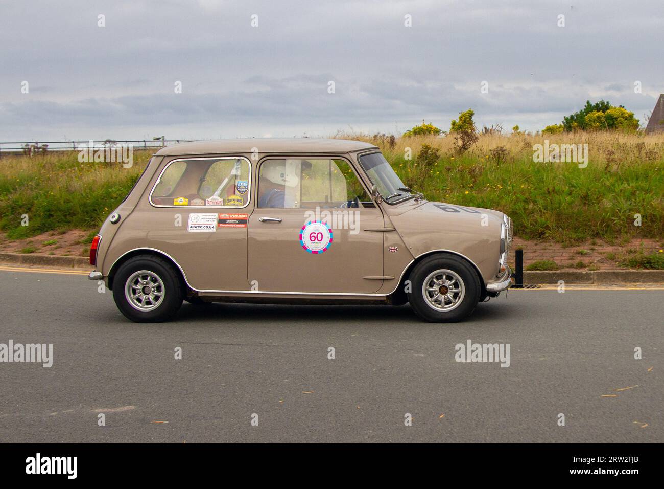 1969 60s sixties Sandy Beige Morris Mini Mk2 1275cc  Beige Petrol  Speed Revival Southport Sprint on Marine Drive, classic and speed on a closed public road Coastal Road historic sprint course, Merseyside, UK Stock Photo