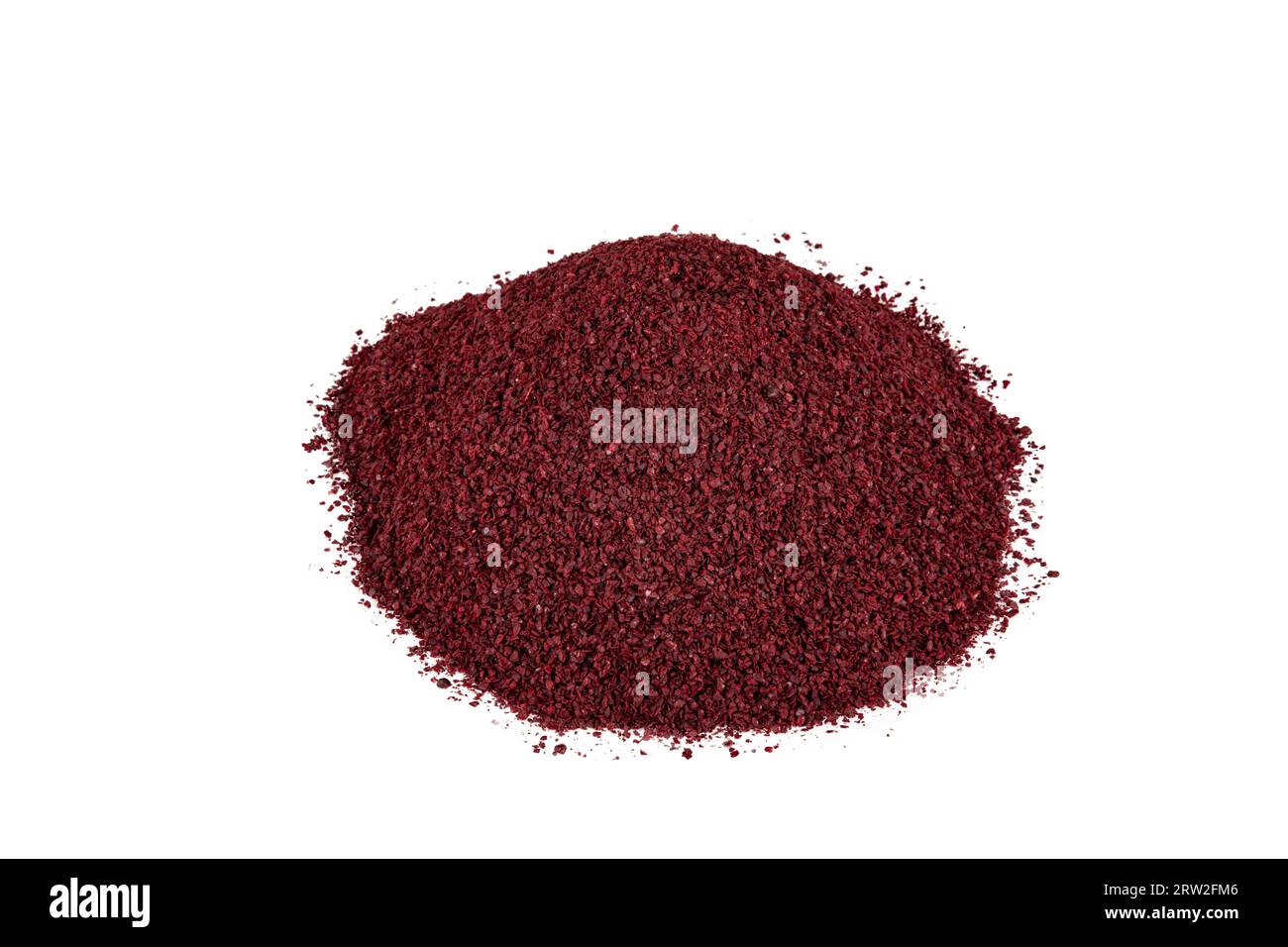Dry spice sumac in a wooden spoon. Ground sumac spice. Dried ground red