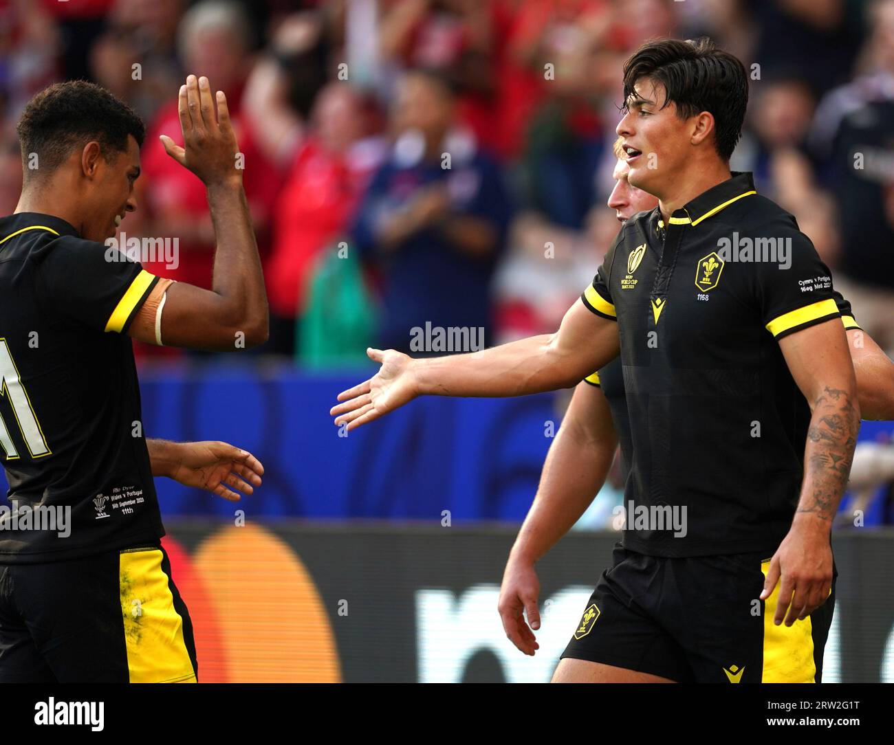 Wales' Louis Rees-Zammit (right) celebrates scoring their side's first try of the game with team-mate Rio Dyer during the Rugby World Cup 2023, Pool C match at the Stade de Nice, France. Picture date: Saturday September 16, 2023. Stock Photo