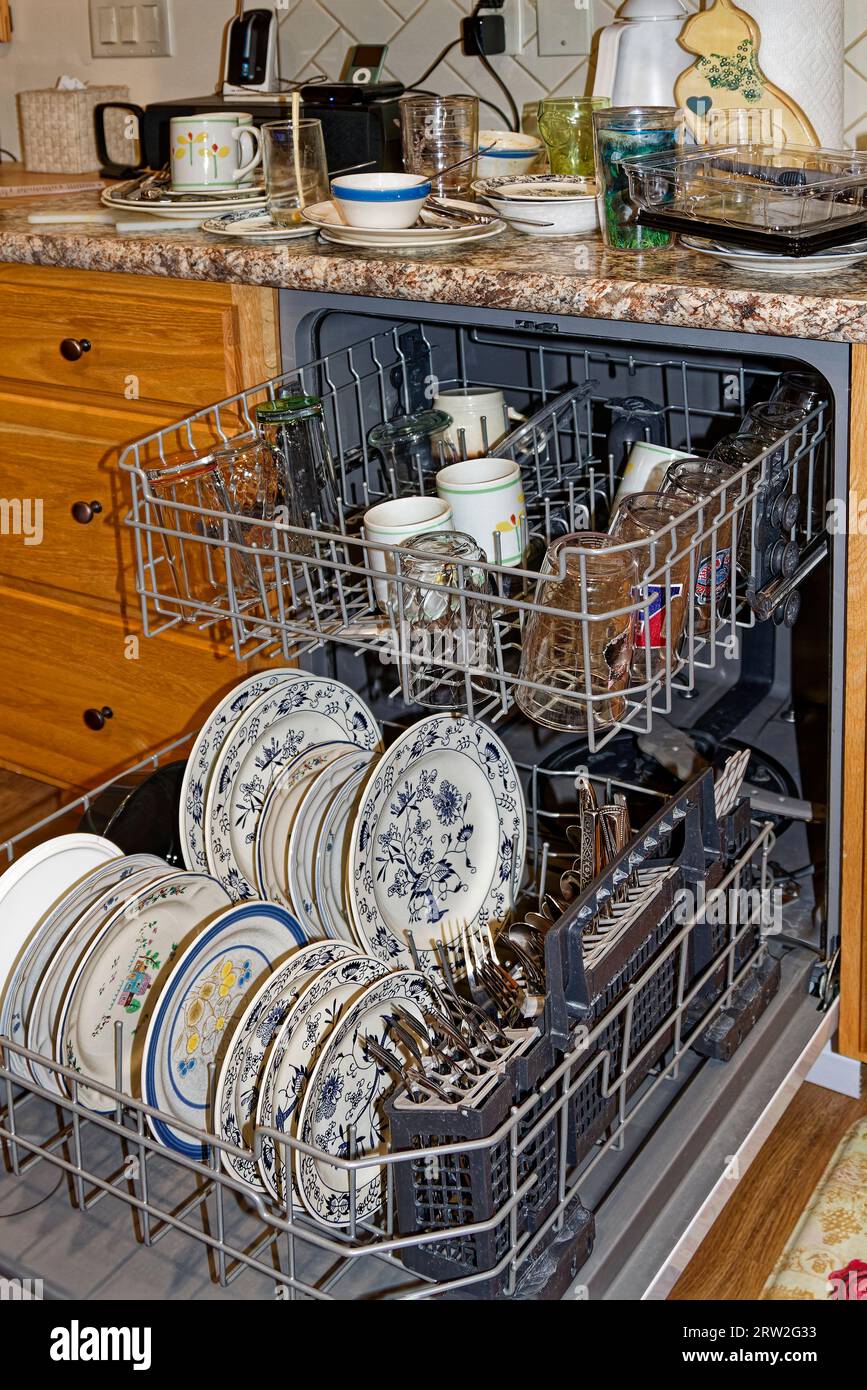 dishwasher open, dirty dishes inside, dirty dishes on counter