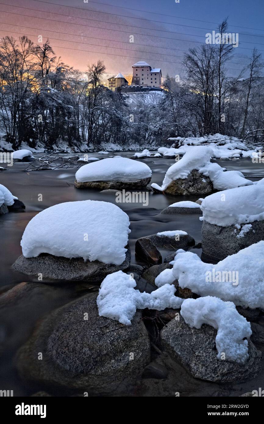 The Noce stream and the medieval castle of Caldes on a winter night. Sole Valley, Trentino, Italy. Stock Photo